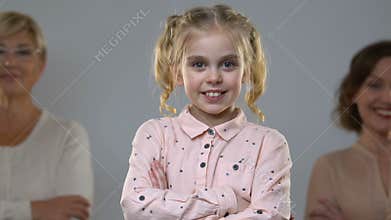Little girl and two women isolated on background, children rights, adoption
