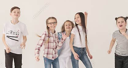 Happy children dancing and jumping in studio