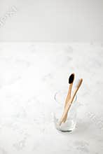 Bamboo teeth brush on minimalistic backgroud. zero waste concept, white background, eco friendly modern simple idea, copy space