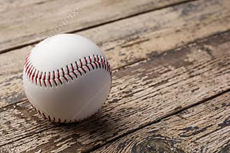 Baseball ball on old rustic wooden backstage.