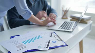 Close up of business people working with laptop in office