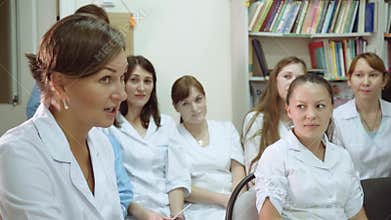 The head of the medical clinic conducts a lecture in the department of the hospital with the staff of the hospital.