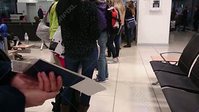 Nervous people in long queue waiting for passport control at customs checkpoint