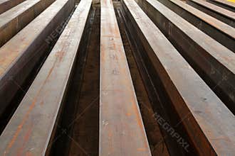 Rusty I-beams arranged in rows