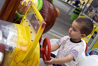 Boy driving car toy