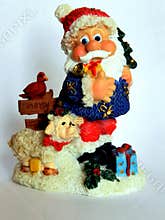 Miniature ceramic figurine of cheerful Santa Claus isolated on white background who carries gifts and wishes all Merry Christmas!