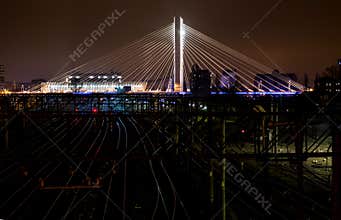 Illuminated Suspended bridge over railway urban modern landmark city night scene