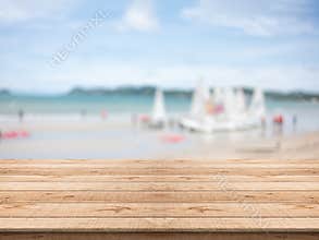 Empty wooden table in front with blurred background at the beach