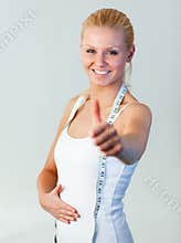 Beautiful woman with thumb up after weight loss