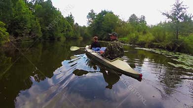 Couple of tourists boating on river, wild nature, active rest