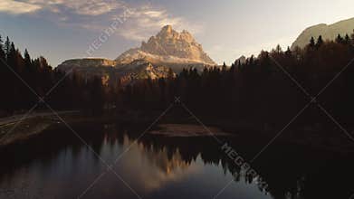 Sunrise over Alpine mountain peaks, forest and Braies Lake. Dolomiti Alps, South Tyrol