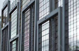 Detail square metal frame with wire mesh fence panels.