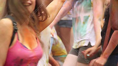 Young girls having fun at festival, waving hands to music