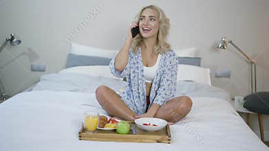 Woman taking on phone during breakfast