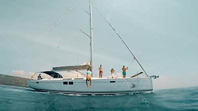 Tourist man jumped in water from yacht.
