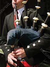 Bagpiper blowing his pipes