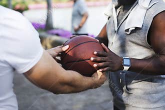 People passing a basketball to another