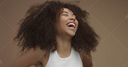 Mixed race black woman portrait with big afro hair, curly hair