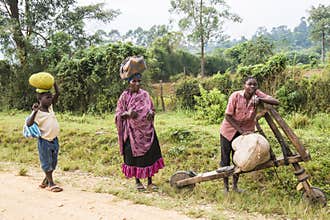 People carry havy loads on head or wooden roller in Africa