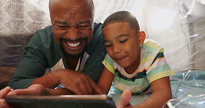Father and son using digital tablet in bedroom 4k