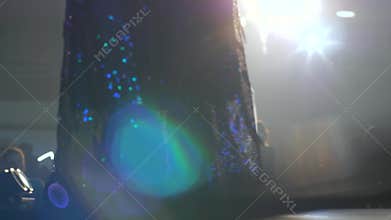 Models in chic evening dresses close up posing on catwalk on background of smoke and light