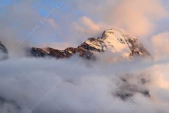 The Swiss mountain Eiger in clouds and evening sun