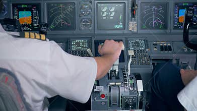 Pilot`s hand is located on a throttle lever in an aircraft cockpit