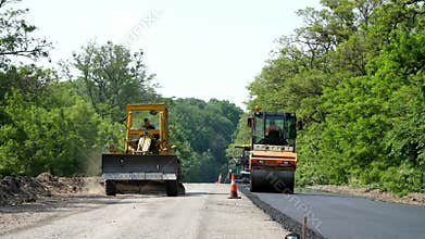 Repair of a highway, roller compactor machine and asphalt finisher laying a new fresh asphalt pavement, covering on one