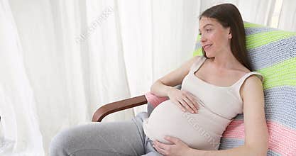 Young happy woman in expectancy