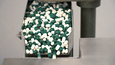 Gelatin capsules spill out from pills machine