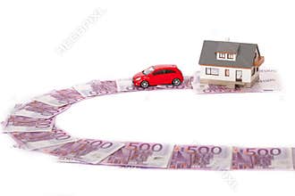 Model house, car and five hundred euro banknote road