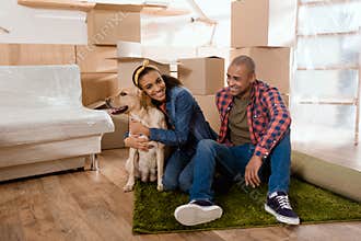 young happy african american family with labrador dog moving to