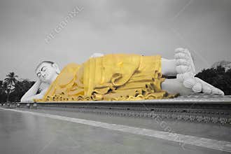 Full view of large Mya Tha Lyaung Reclining or sleeping Buddha in black and white with yellow robe