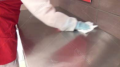 Cleaning and washing cutting table.