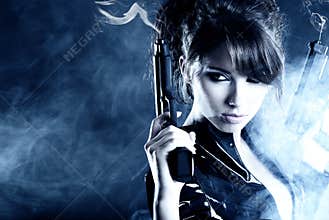 Beautiful girl holding gun