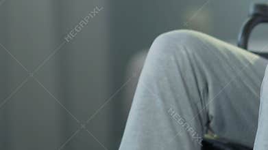 Elderly man in wheelchair pushing it forward, post-accident condition, diagnosis