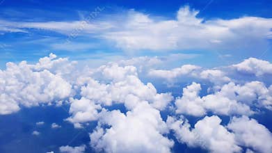 View of clouds and sky through airplane window