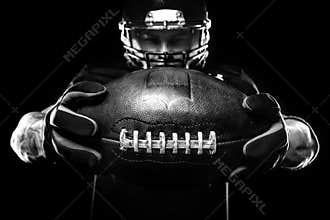 Sport concept. American football sportsman player on black background. Sport concept.