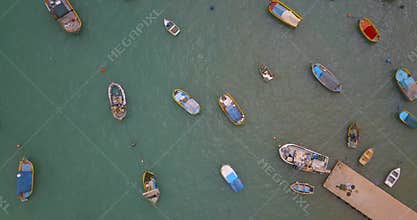 Aerial view on the mediterranean traditional colorful boats luzzu