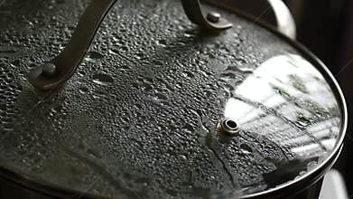 Pan with fogged lid. cooking at home. 4K