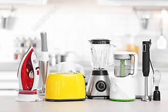 Household and kitchen appliances on table indoors