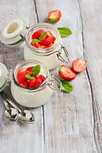 Homemade natural yogurt with strawberries and mint.
