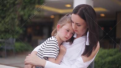 Little girl crying sitting on mother