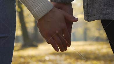 Close-up of boyfriend and girlfriend clasping each other hands in slow-motion
