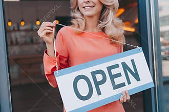 cropped shot of happy small business owner holding sign