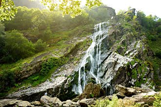 Majestic water cascade of Powerscourt Waterfall, the highest waterfall in Ireland.