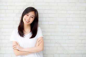 Portrait of beautiful young asian woman happiness standing on gray cement texture grunge wall brick background.