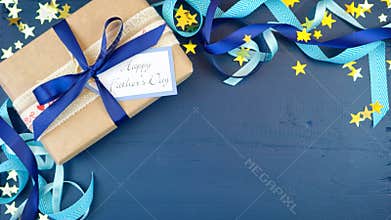 Father`s Day overhead with decorated borders on dark blue wood table.