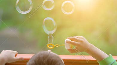 Little boy blowing soap bubbles