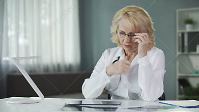 Concerned female pulmonologist examining X-ray of patient's lungs, diagnostics